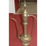 An oversized Persian style brass coffee pot and cover, having all-over floral decoration, h.92cm