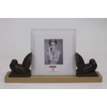 An Art Deco photo frame, the central frame flanked by two bronze metal doves on rectangular plinth