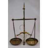 A pair of 19th century brass balance scales, on a tripod base by De Grave Short Fanner & Co of