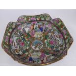 A Chinese canton bowl profusely enamel decorated with figures, flowers and birds, having shaped rim,
