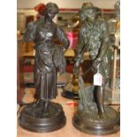A pair of Spelter figures of farm workers, him with scythe in hand and her with flowers in hand,