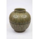 A Chinese export stoneware vase of globular form on a green ground with incised decoration, height