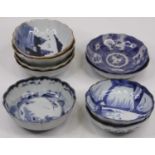 A collection of nine Chinese blue and white dishes, each painted with a landscapeAll with firing
