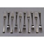 A set of ten Edwardian silver table forks, in the Old English pattern, each terminal with engraved