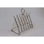 A novelty silver plated toast rack in the form of rifles