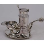 A novelty silver plated cruet in the form of riding boots and a jockey cap upon a spur, h.9cm