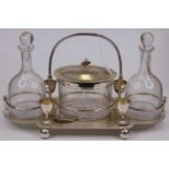 A Victorian style silver plated cruet, having central biscuit barrel flanked by two glass