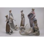 A Lladro Spanish porcelain model of a woman, in standing pose with flowers in her hand, having