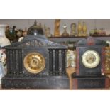 A Victorian black slate mantel clock, of architectural form, having an arched top surmounted by a