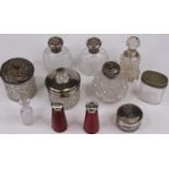 A collection of Victorian and later scent bottles and dressing table jars, with silver and plated