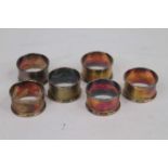A set of six George V silver napkin rings, each with engine turned decoration and vacant