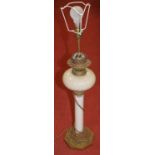 A Victorian oil lamp, having an opalescent glass font on a milk glass column and embossed brass