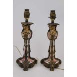 A pair of 19th century porcelain candlesticks, each hand painted with flowers and having gilt