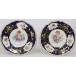 A pair of late 19th century Derby cabinet plates, the centre painted with a group of flowers