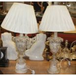 A pair of carved alabaster table lamps, each of leaf-capped urn form, on turned socle base with