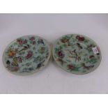 A pair of Chinese celadon plates, each enamel decorated with flowers, butterflies and birds, dia.