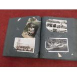 A mid 20th century postcard album containing George V and later postcards, to include
