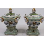 A pair of continental porcelain pot pourri vases, each having a gilt pineapple finial on a