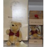 A Steiff Winnie the Pooh soft toy with moving limbs in red waistcoat with button to ear and white