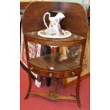 An early 19th century mahogany bowfront three tier wash stand, with ironstone jug and bowl