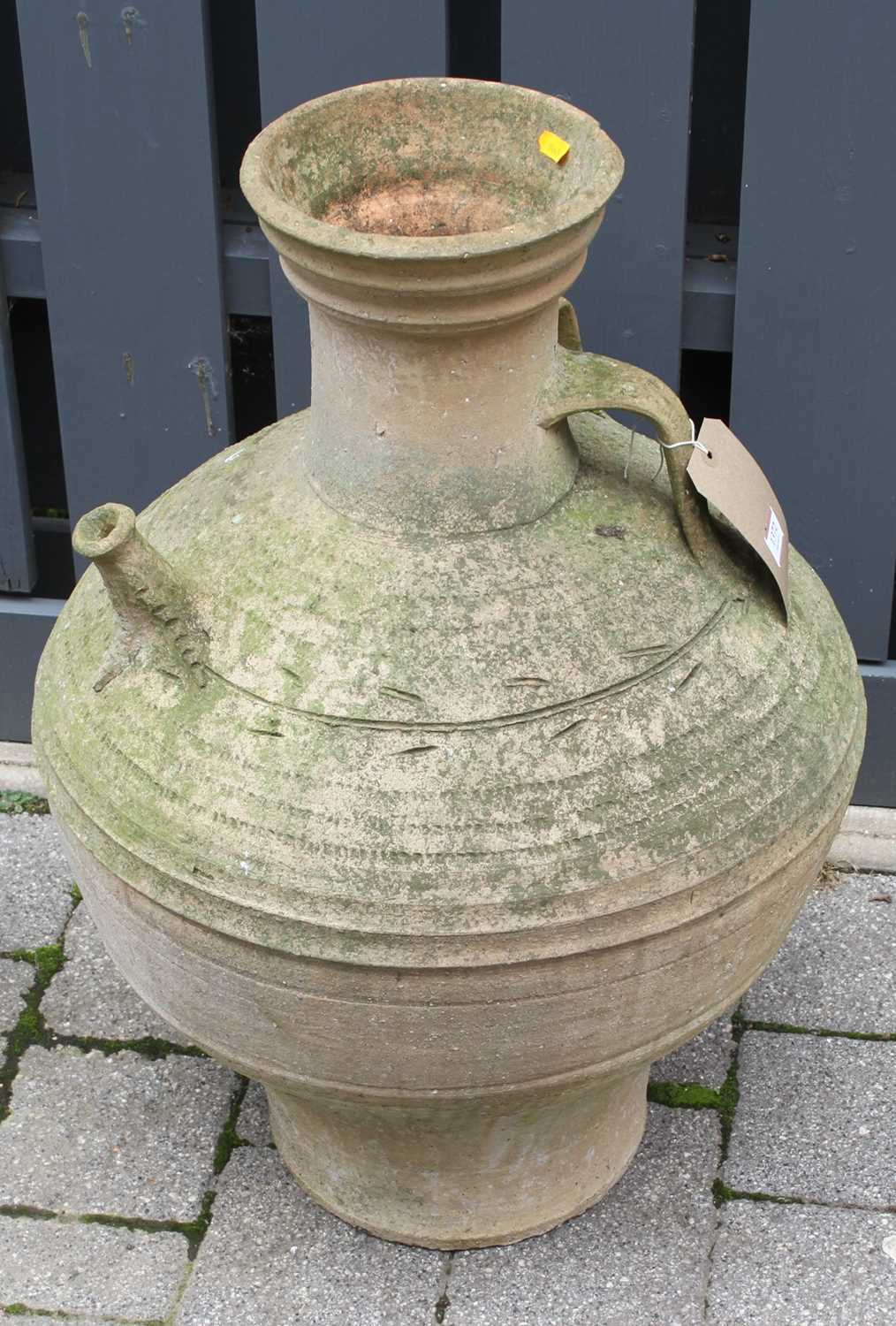 A terracotta single handled bulbous garden water urn, with narrow protruding spout, height 69cm