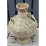 A terracotta single handled bulbous garden water urn, with narrow protruding spout, height 69cm