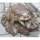 A fibreglass garden figure of a frog on integral naturalistic base, length 55cm