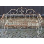 A wrought metal floral scroll decorated two-seater garden bench, width 129cmSolid and stable, but