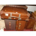 A collection of sundry vellum and canvas suitcases, travelling trunks etc