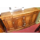 A late Victorian oak breakfront four door side cupboard, w.151cm