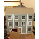 A wooden kit built three storey open front dolls house with a quantity of dolls house furniture