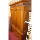 A Victorian oak converted wardrobe, having twin arched recessed panelled upper doors over two