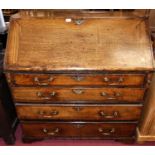 A George III provincial oak and mahogany cross banded slopefront writing bureau, of four long