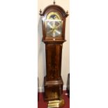 A contemporary mahogany and flame mahogany longcase clock, having arched brass and sivered moon