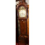 An early 19th century mahogany and flame mahogany longcase clock having an arched painted dial,