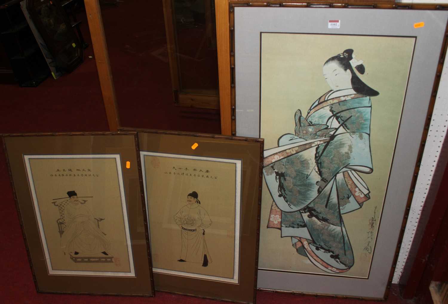 A pair of Japanese school prints of seated immortals; together with a further Japanese colour