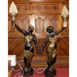 A large pair of French bronzed metal freestanding figural lamps, each in the form of a standing
