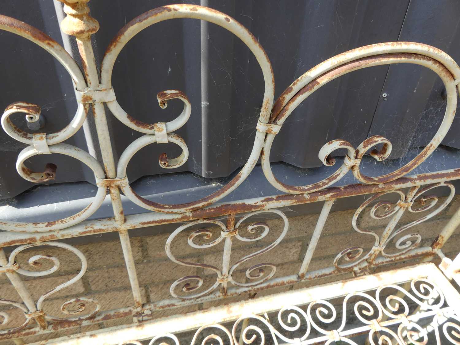 A wrought metal floral scroll decorated two-seater garden bench, width 129cmSolid and stable, but - Image 3 of 3