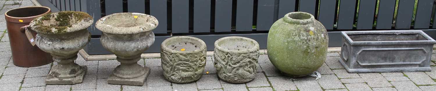 A pair of reconstituted stone footed garden urns, together with a further pair of reconstituted