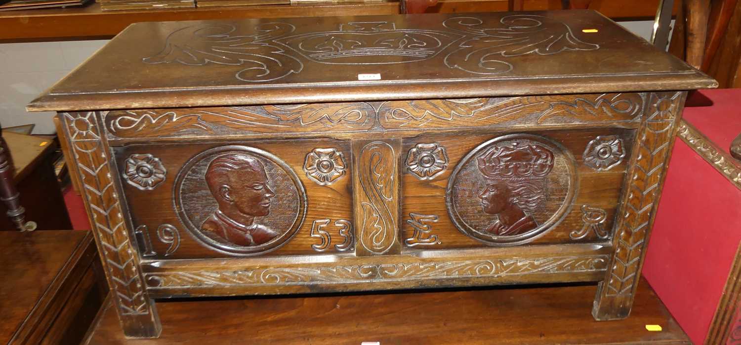 A mid-20th century line carved oak twin panelled blanket chest, each panel with Monarchs portrait