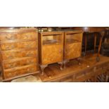 A mid-20th century figured walnut bedside chest of five long drawers, together with a pair of