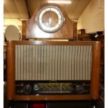 A 1950s walnut cased radio, together with a 1930s figured walnut striking and chiming mantel