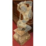 A painted composite model of a South-East Asian semi-nude dancing figure, raised on rustic