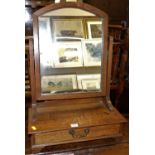 An Arts & Crafts oak swing dressing mirror, raised on plain single drawer box base, with furnisher's