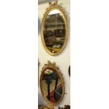 A pair of contemporary French style oval giltwood wall mirrors, with ribbon surmount and gadrooned
