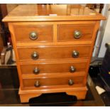 A small contemporary yew wood bedside chest of two short over three long drawers, width 42.5cm
