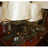 A collection of six various contemporary panelled glass table lamps, each with shades