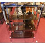 A contemporary flat sided chrome and smoky glass four tier open display shelf, of allen key