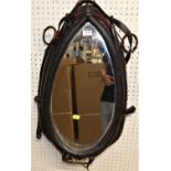 A novelty leather and metal clad wall mirror, fashioned from a horse harness collar, 64 x 41cm
