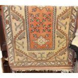 A small Persian woollen rust ground Shiraz rug, having flat weave ends, 150 x 81cm